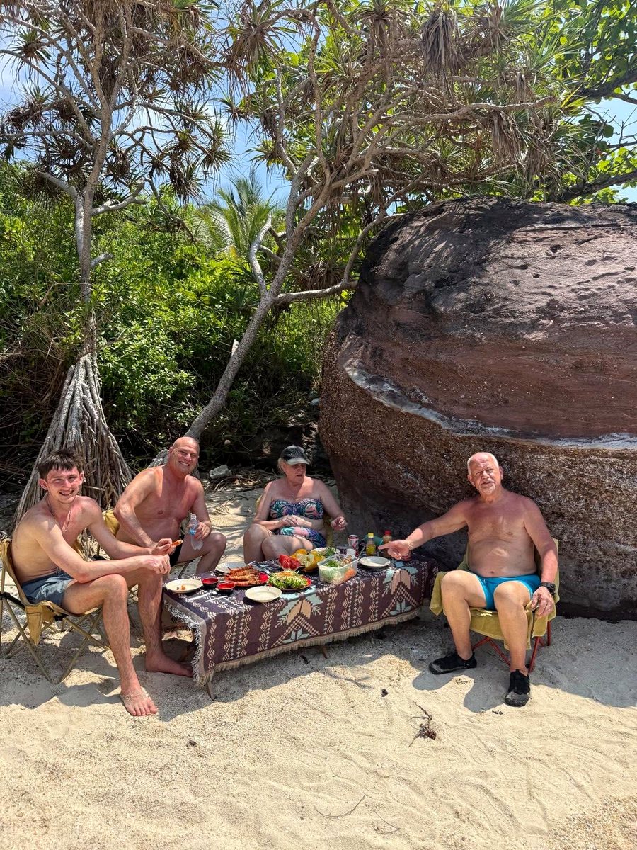 Guests enjoying seafood lunch in a quiet private cove during a Phu Quoc island tour package