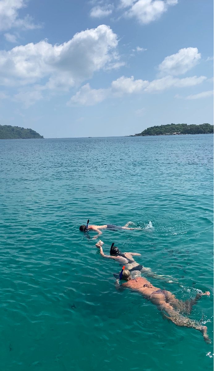 Guests snorkeling over clear coral water on a Phu Quoc island tour package